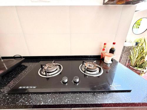 a stove top with two tea pots on top of it at myRoom at 11, Jalan Adams Georgetown in George Town