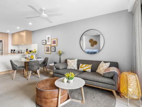 a living room with a couch and a table at Lux 2BR Apt 5 Stars Hotel Pool Gym 10 min CBD in Brisbane