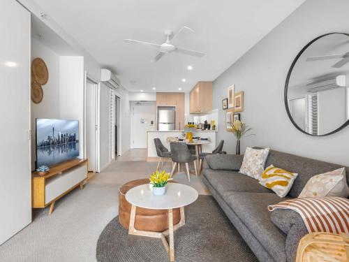 a living room with a couch and a table at Lux 2BR Apt 5 Stars Hotel Pool Gym 10 min CBD in Brisbane