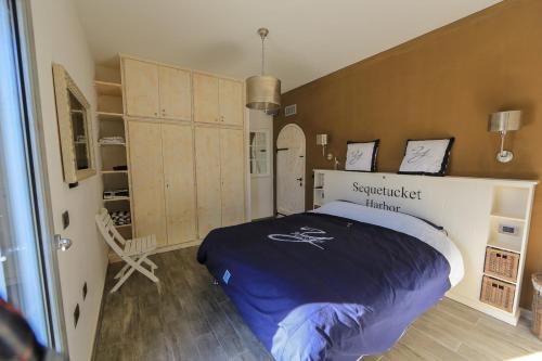 a bedroom with a large bed and a large closet at La Pazienza in Marina di Gairo
