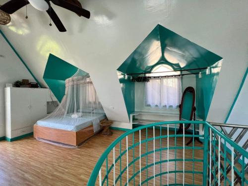 a room with a bed and a staircase in it at Casa De Moore - Ocean & Garden View Siargao in General Luna