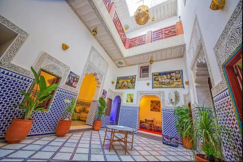 a room with blue and white tiles and plants at Riad Rayhana-Exclusive Riad Experience in Fes Medina in Fès