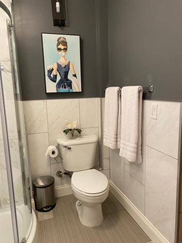 イングルウッドにあるCarousel Lofts - cool space and great locationのトイレ付きのバスルームと女性の写真