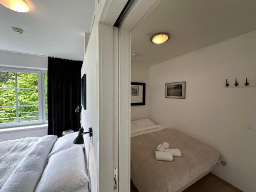 a bedroom with a bed and a window at Sonnenwende by AlpenTravel in Bad Gastein
