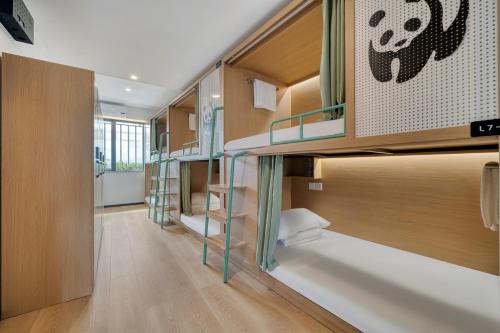 a hallway with bunk beds in a room at Wander Lodge Youth Hostel in Chengdu
