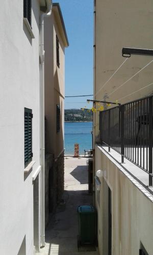 a hallway between two buildings with a view of the water at Villa Neka in Primošten