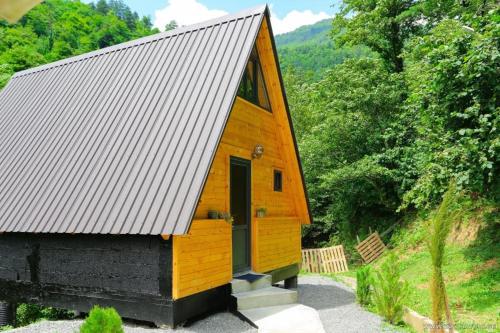 a tiny house with a gambrel roof at Discover Gulebi in Keda