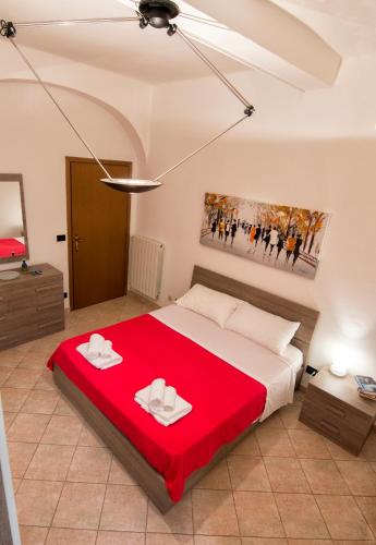 a bedroom with a large bed with a red blanket at Appartamento La Cittadella in Piombino