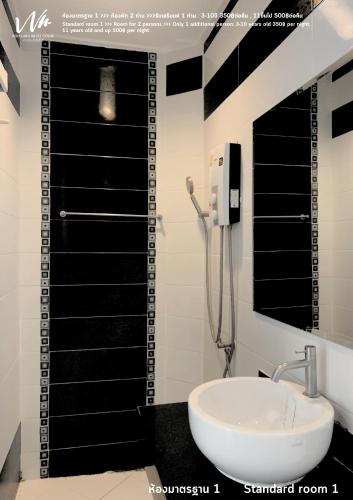 a bathroom with a shower and a white sink at Koh Larn White House in Ko Larn