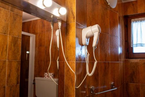 a hairdryer hanging on a wall in a bathroom at Residence Les Coupoles in Champoluc