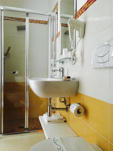 a bathroom with a sink and a shower at Vespucci Apartments Torre Lapillo in Torre Lapillo