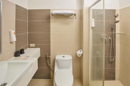 a bathroom with a toilet and a shower at Go Hotels Puerto Princesa in Puerto Princesa City