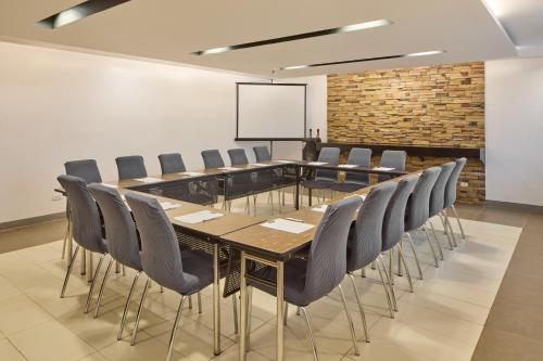 a conference room with a long table and chairs at Go Hotels Puerto Princesa in Puerto Princesa City