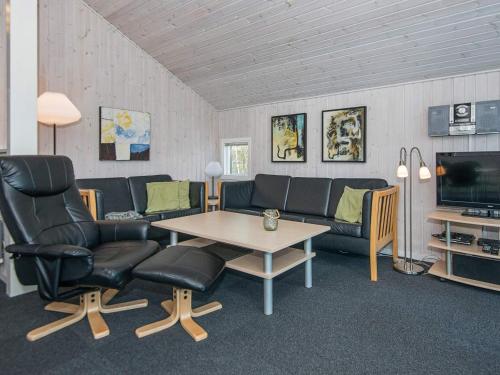 a living room with a couch and a table and chairs at Luxury Spa Retreat in Ebeltoft - By Traum Ferienwohnungen in Ebeltoft