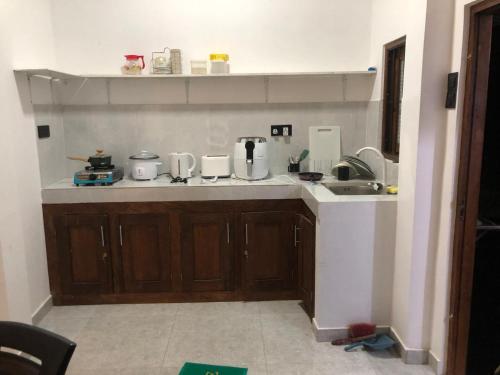 a kitchen with a sink and a counter top at Crystal house in Weligama