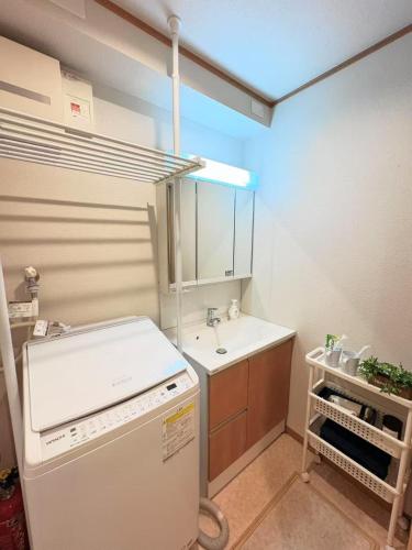 a small kitchen with a sink and a refrigerator at 夏様二条南 6 min walk Nijo St, Entire private house, 3 bedrooms, Up to 6 guests, 2 toilets in Kyoto