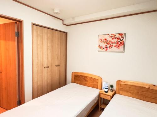 a bedroom with two beds and a closet at 夏様二条南 6 min walk Nijo St, Entire private house, 3 bedrooms, Up to 6 guests, 2 toilets in Kyoto