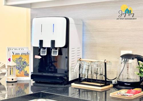 a kitchen counter with a coffee maker on a counter top at The Shore l Luxury 3BR l 6-9pax l Direct Mall Access l City Centre l Melaka River l Jonker Street by Jay Stay Management in Melaka
