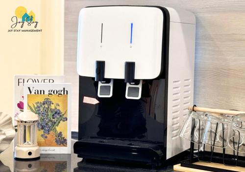 a white and black appliance sitting on a counter at The Shore l Luxury 3BR l 6-9pax l Direct Mall Access l City Centre l Melaka River l Jonker Street by Jay Stay Management in Melaka