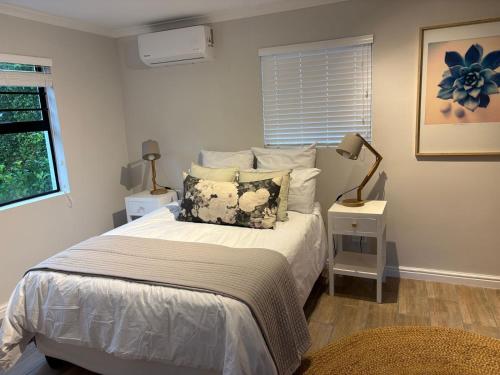a bedroom with a bed with a pillow on it at Suburban Bliss in Stellenbosch