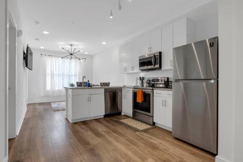 a kitchen with white cabinets and stainless steel appliances at Downtown Atlanta Home Away From Home in Atlanta
