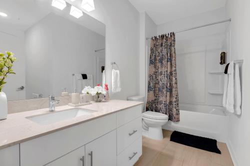a white bathroom with a sink and a toilet at Downtown Atlanta Home Away From Home in Atlanta