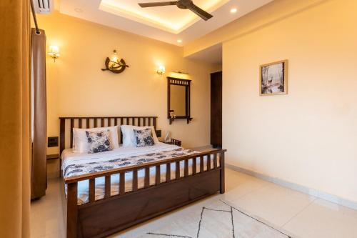 a bedroom with a bed and a ceiling fan at Peace Stay 2BHK Villa in Bhīm Tāl