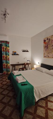 a bedroom with a large bed with a green table at Da Jack Rooms, la tua casa vacanze! in Penne