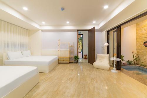 a bedroom with two beds and a tub at Danang's house in Da Nang