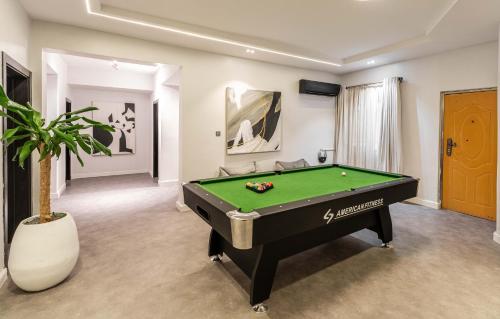 a pool table in a living room with a pool at George Residence SDA Court, Banana Island, Ikoyi in Lagos