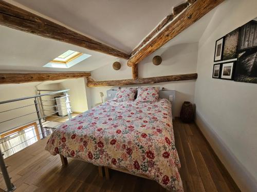 een slaapkamer met een bed met een rood dekbed bij Le nid douillet in Pertuis