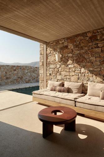 a living room with a bed and a coffee table at Perma Serifos in Serifos Chora