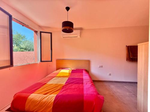 a bed in a room with a large window at Villa cosy avec piscine à Collioure in Collioure