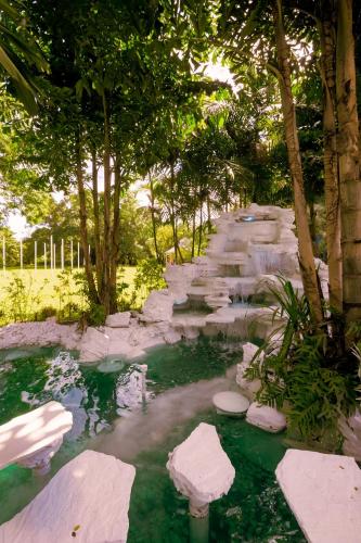 a path through a garden with rocks and trees at Sheva Om in Ban Wat Pho Thong