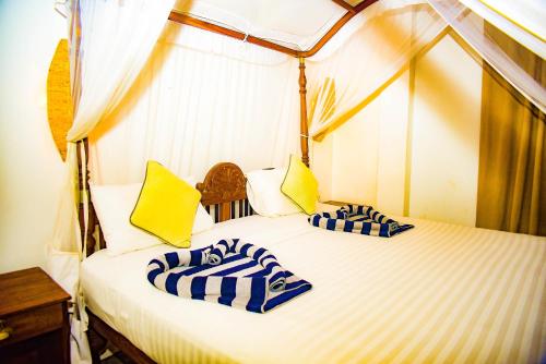 a bedroom with two beds in a tent at Birds Cabana in Unawatuna