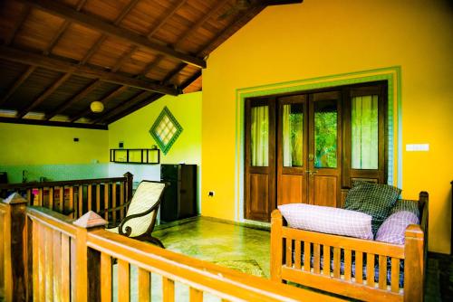a porch of a house with a wooden railing at Birds Cabana in Unawatuna