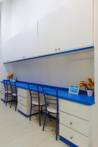 an office with a blue and white counter with chairs at Sheva Om in Ban Wat Pho Thong