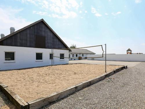 a volleyball court with a net in front of a building at 20 person holiday home in Vinderup-By Traum in Vinderup
