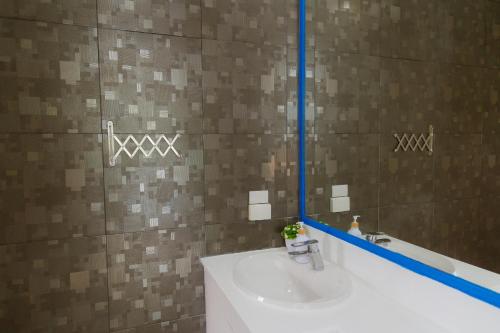 a bathroom with a sink and a mirror at Sheva Om in Ban Wat Pho Thong
