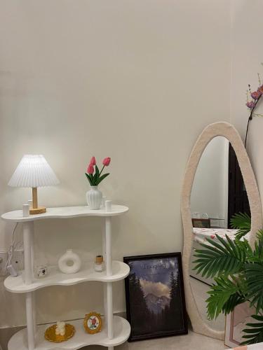 a room with two white shelves and a mirror at Danang's house in Da Nang