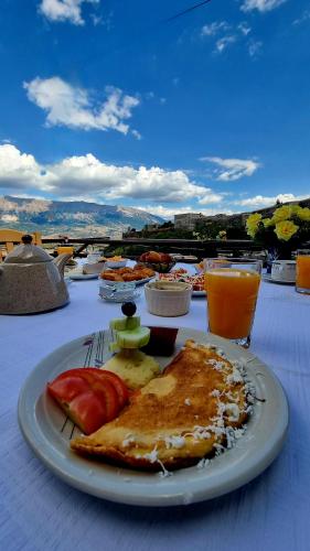 a plate of food sitting on a table with food at Çelo's house Gjirokaster in Gjirokastër
