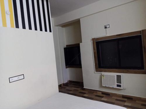 a living room with a large flat screen tv at The Rajabhoj palace Hotel in Bhopal
