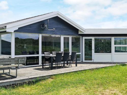 una veranda riparata con tavolo e sedie di 8 person holiday home in Ringkøbing-By Traum a Ringkøbing