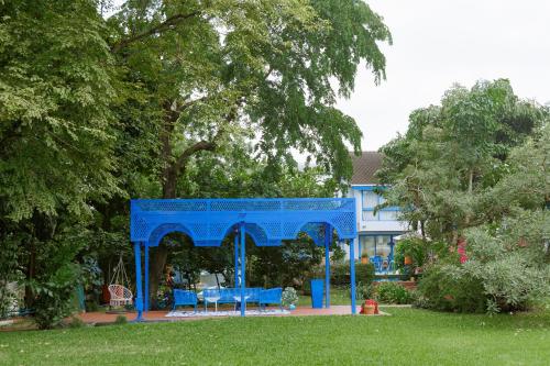 a blue gazebo in front of a house at Sheva Om in Ban Wat Pho Thong