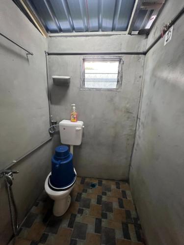 a small bathroom with a toilet and a window at Mahsuri Dorm, Roomstay & Homestay Langkawi in Ulu Melaka