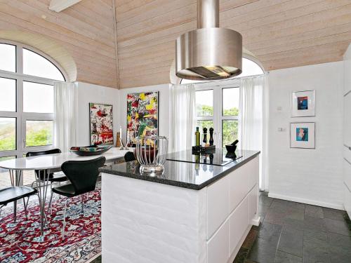 a kitchen with a table and a dining room at Luxury Seaside Retreat - By Traum Ferienwohnungen in Søndervig