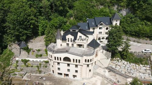 a large white house with a black roof at Zámoček Mraznica in Prievidza