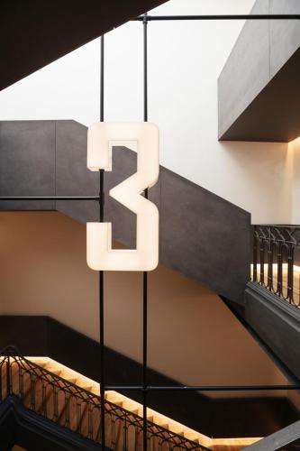 a staircase with the number two hanging from a building at Inspira Santos Boutique Hotel in Lisbon