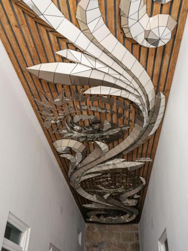 a ceiling in a building with a painting on it at Inspira Santos Boutique Hotel in Lisbon