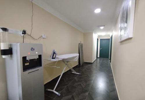 a room with a desk and a table in it at Fast Hotel Idaman Near To IIUM KL in Kuala Lumpur